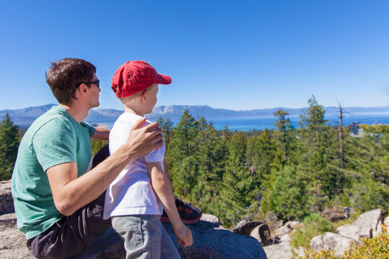 Father and son looking at the views overlooking Lake Tahoe