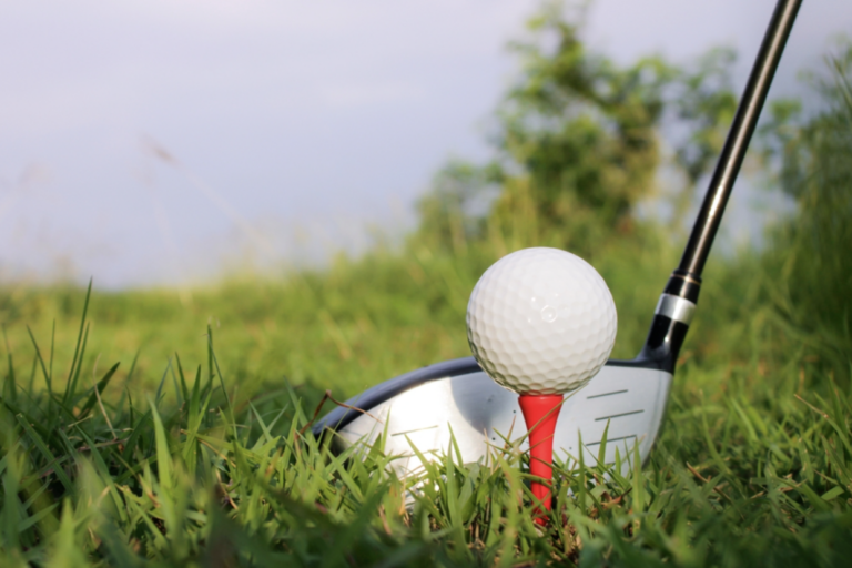 golf club hitting a golf ball