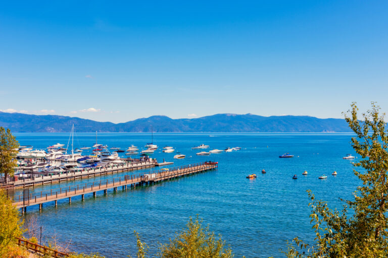 View of the Tahoe City waterfront with boats and mountains in view